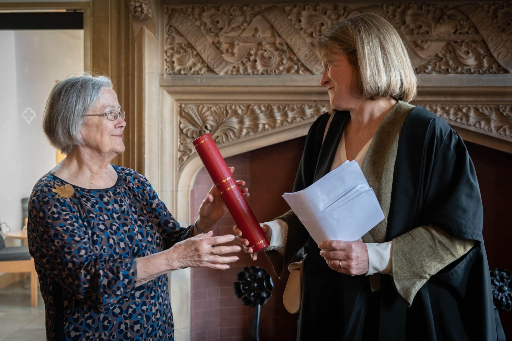 Helen handing Lady Hale's honorary fellowship certificate