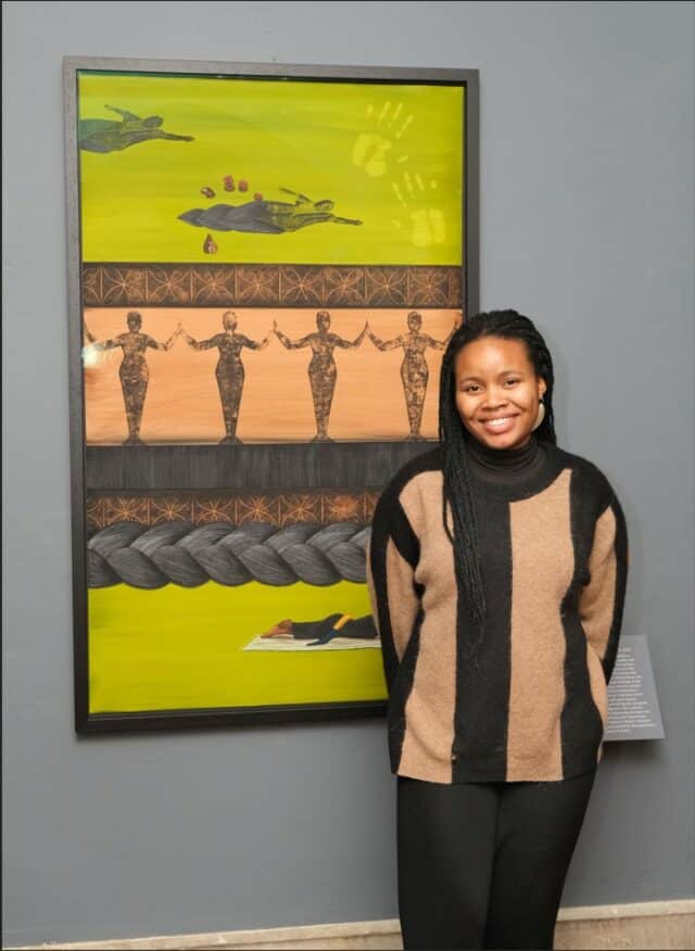 Bumni agusto standing by her art work