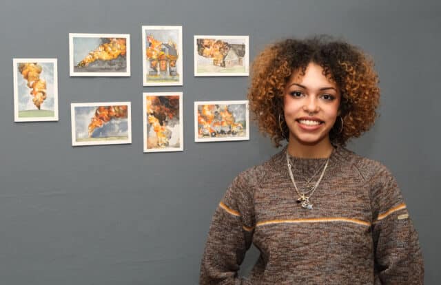 Paige Diedrick-Edwards in front of her artwork 'Little Fires Everywhere'