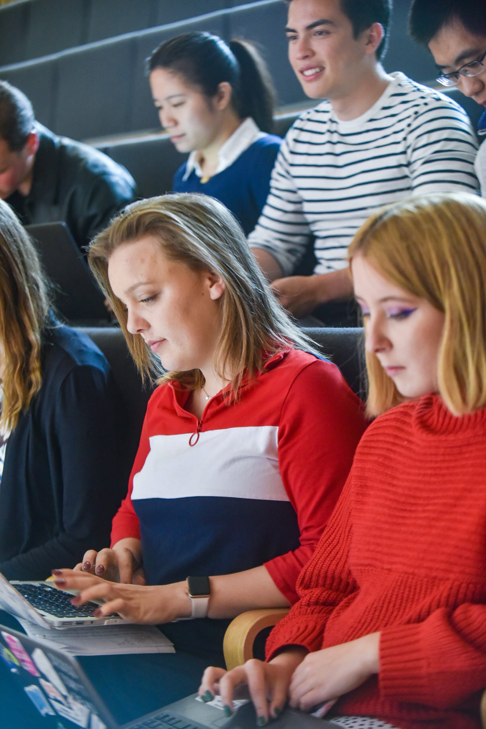 Photo of students in BIHR Lecture looking at laptop.