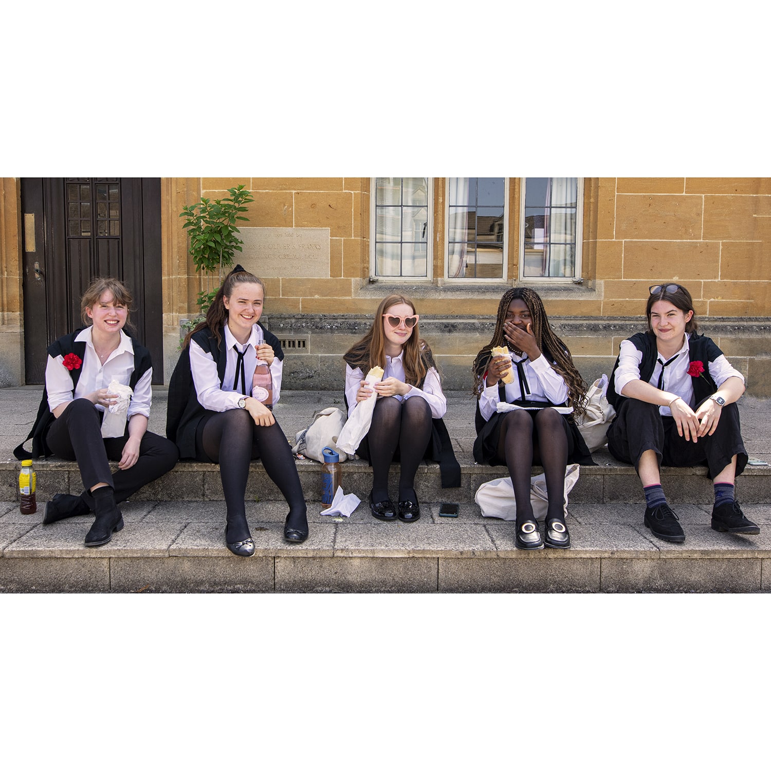 Photo of students on their last day of exams wearing red carnations.