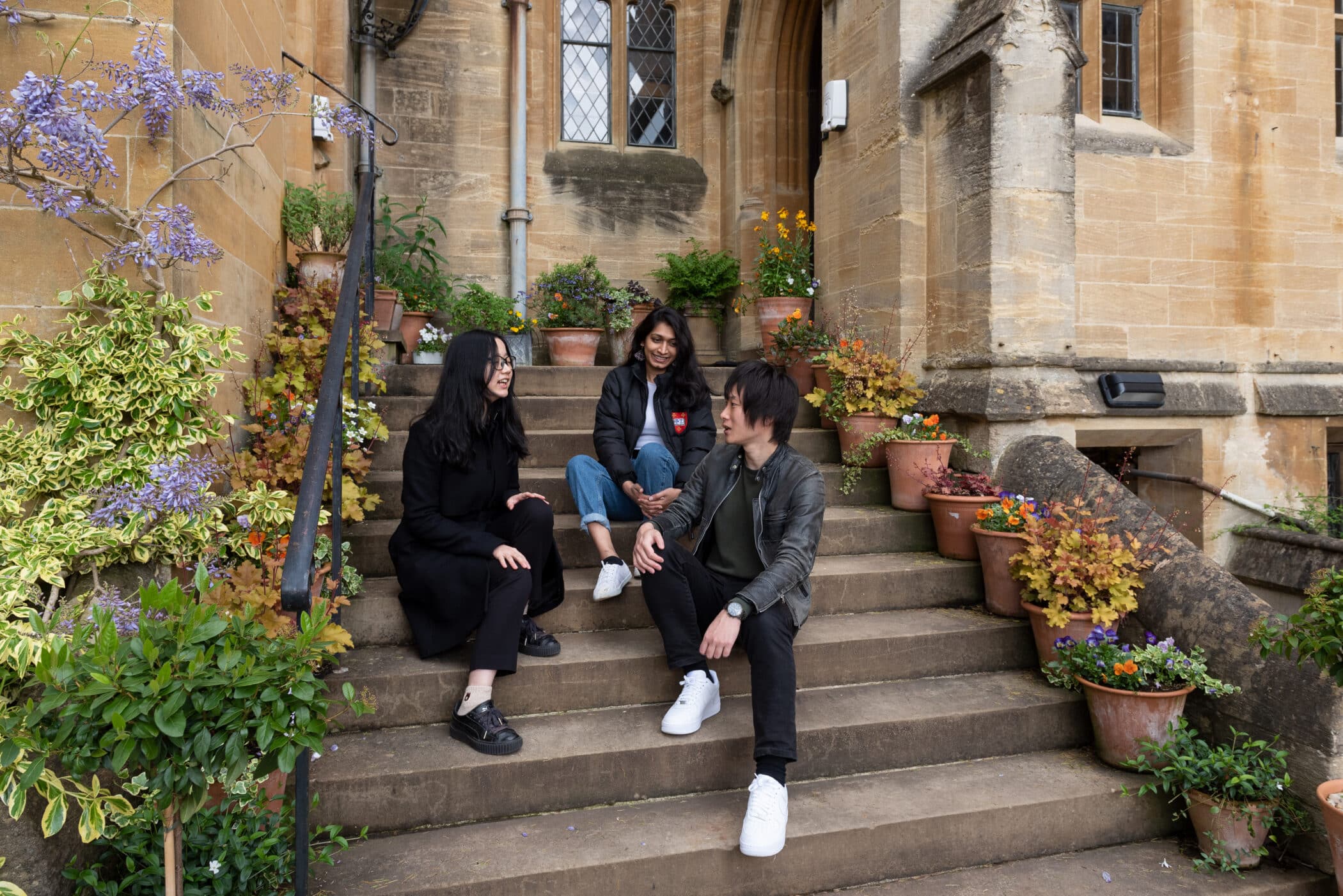 Students talking on the steps of the Principal's Lodgings.