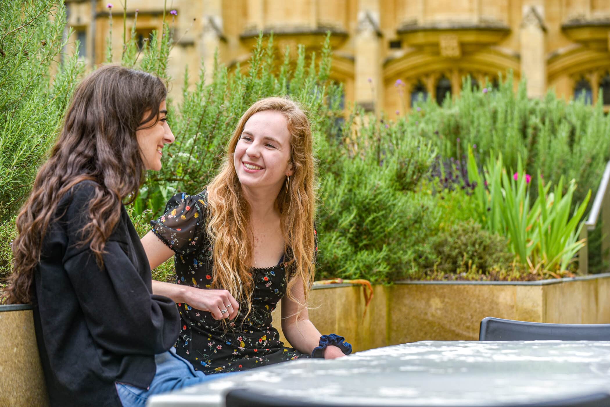 Students talking in the outdoor area of the crypt cafe.