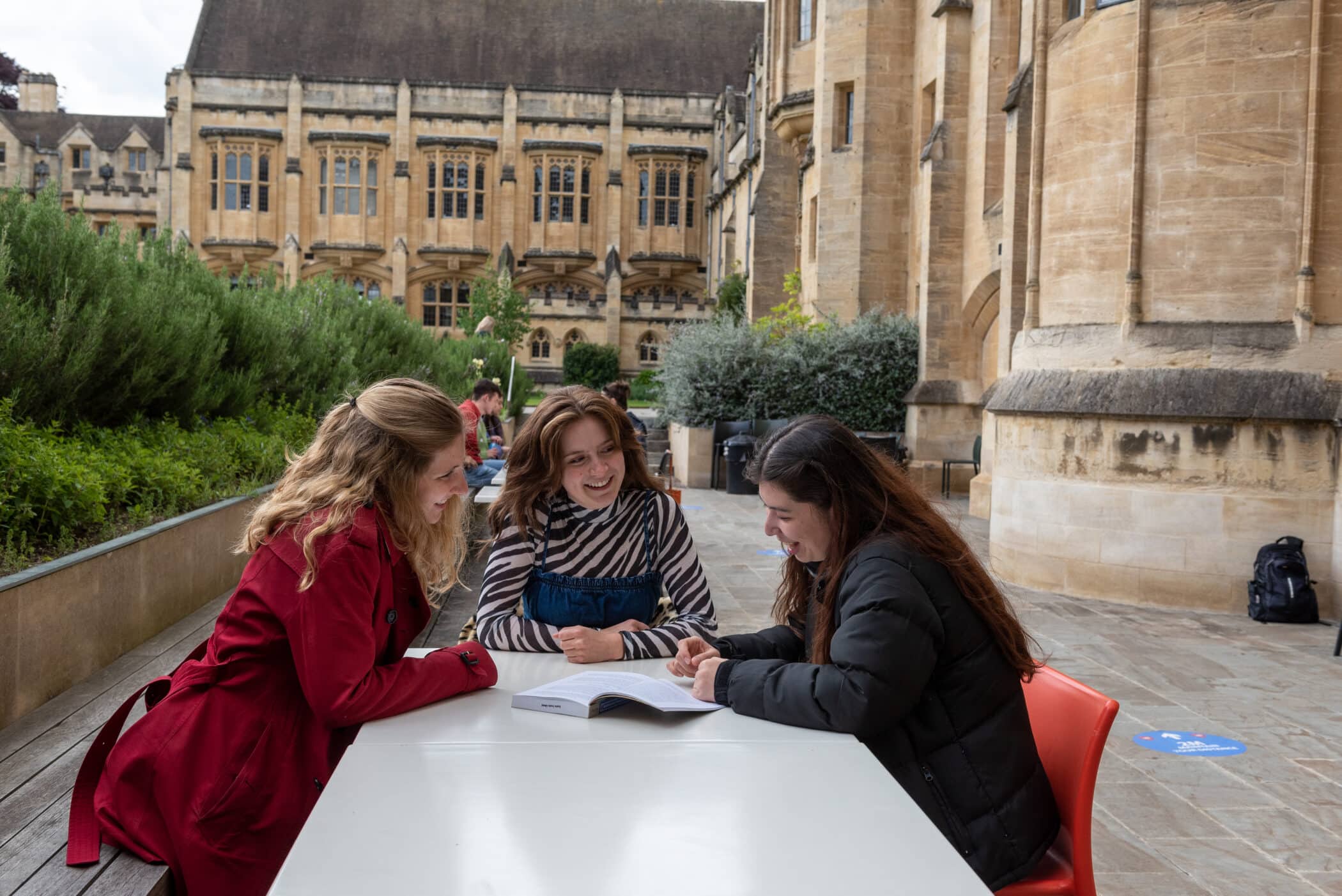 Students talking in the outdoor area of the crypt cafe.