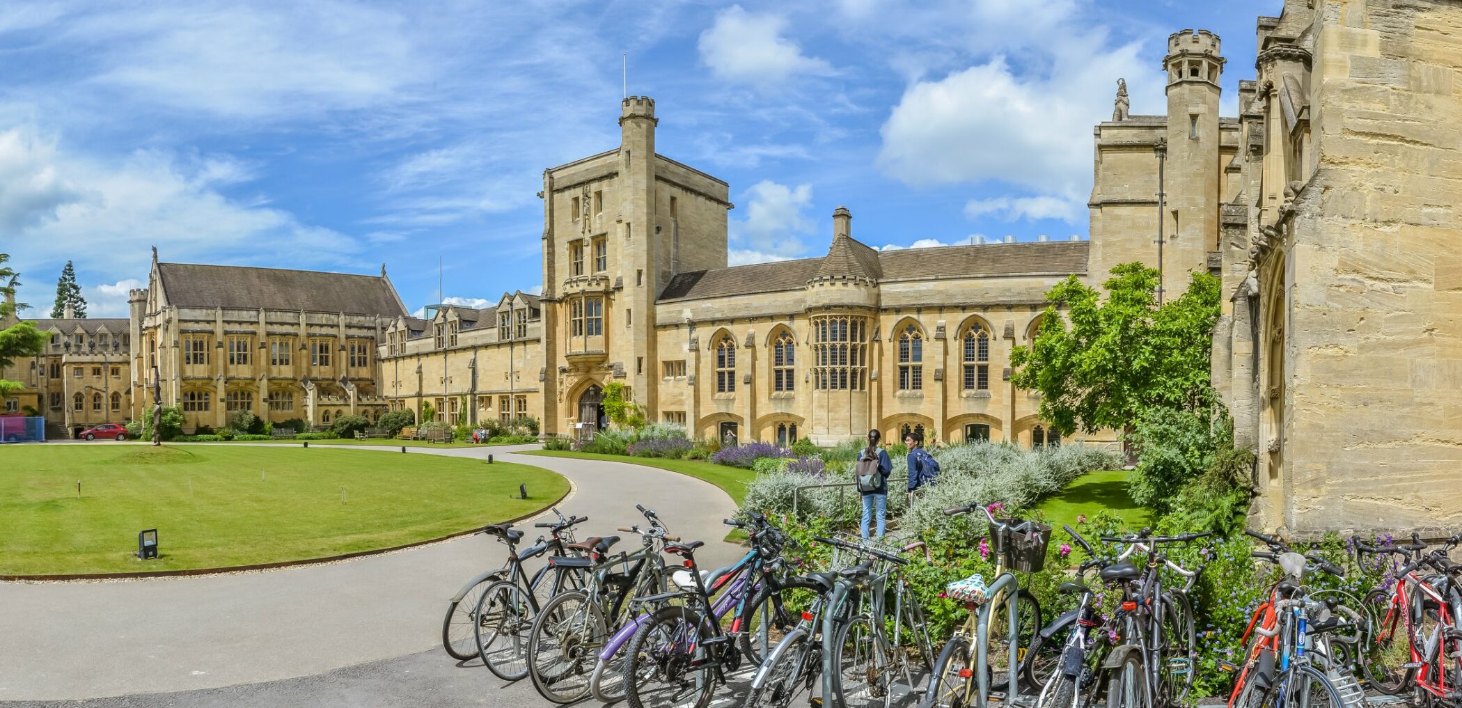 View of the Main Building from the car park. Two students in the background.