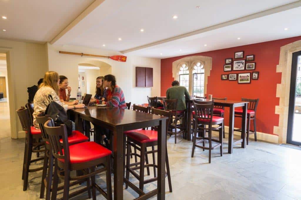 students chatting the crypt cafe bar area