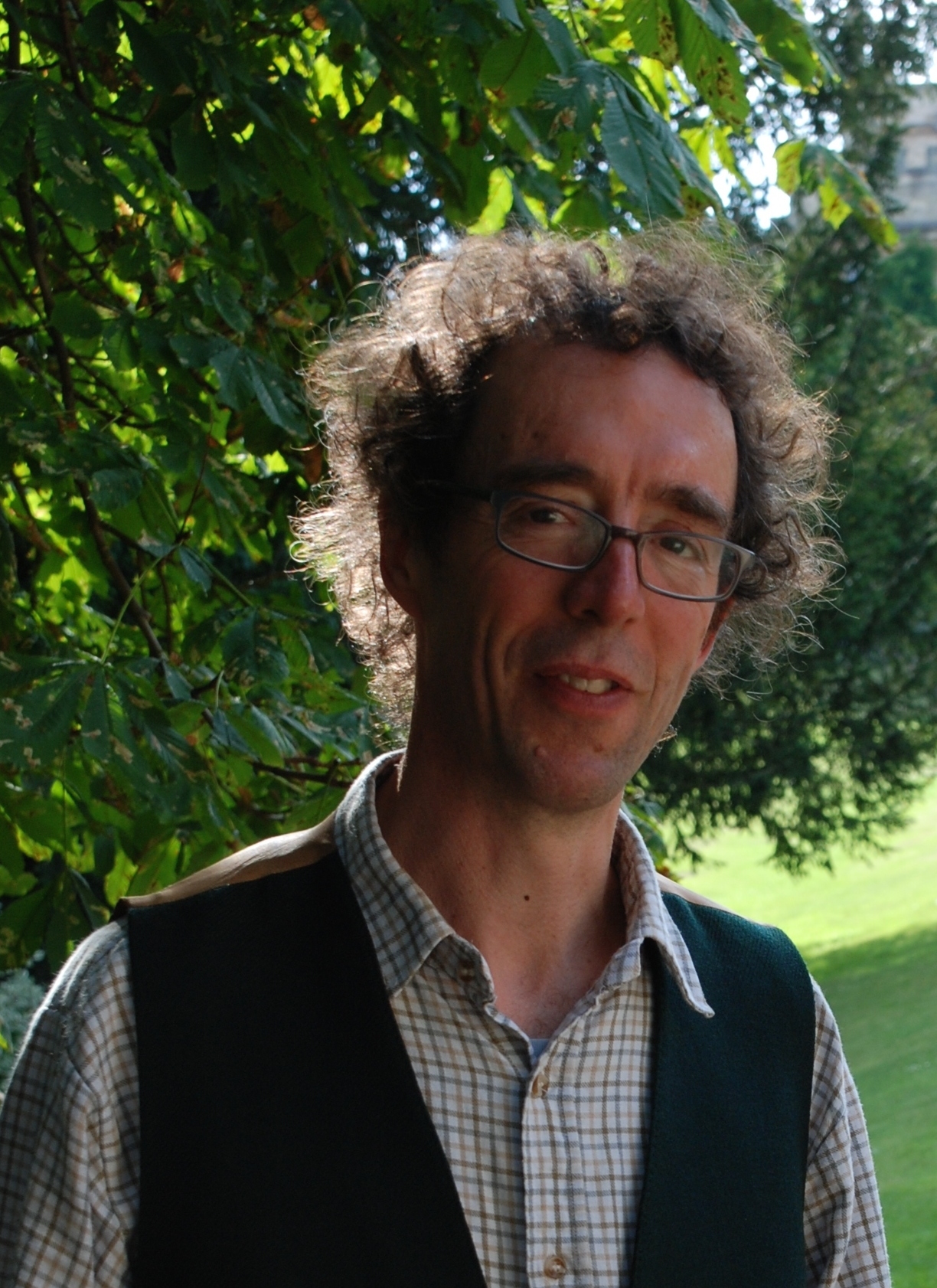 headshot of Mark Atherton with a green background