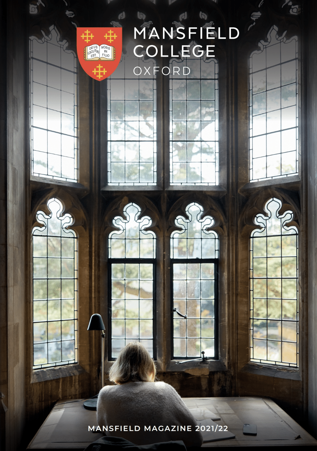 Student studying in Library with window in background Magazine 2021/22 front page.