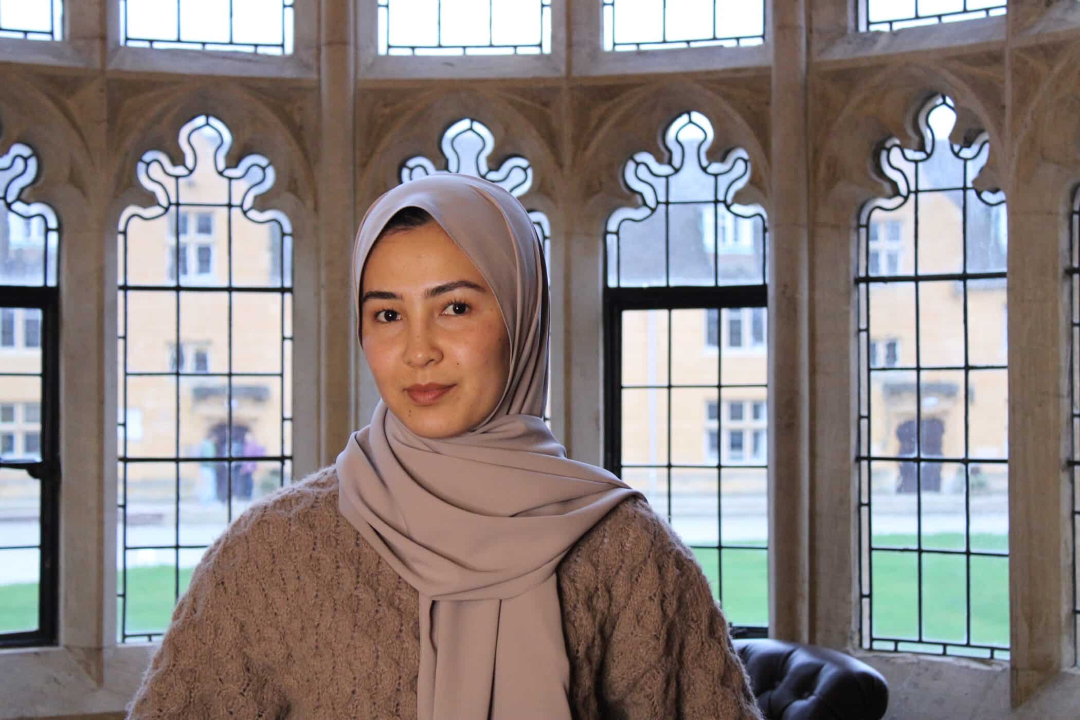 Photo of Shukria Rezaei with arched windows overlooking Mansfield quad