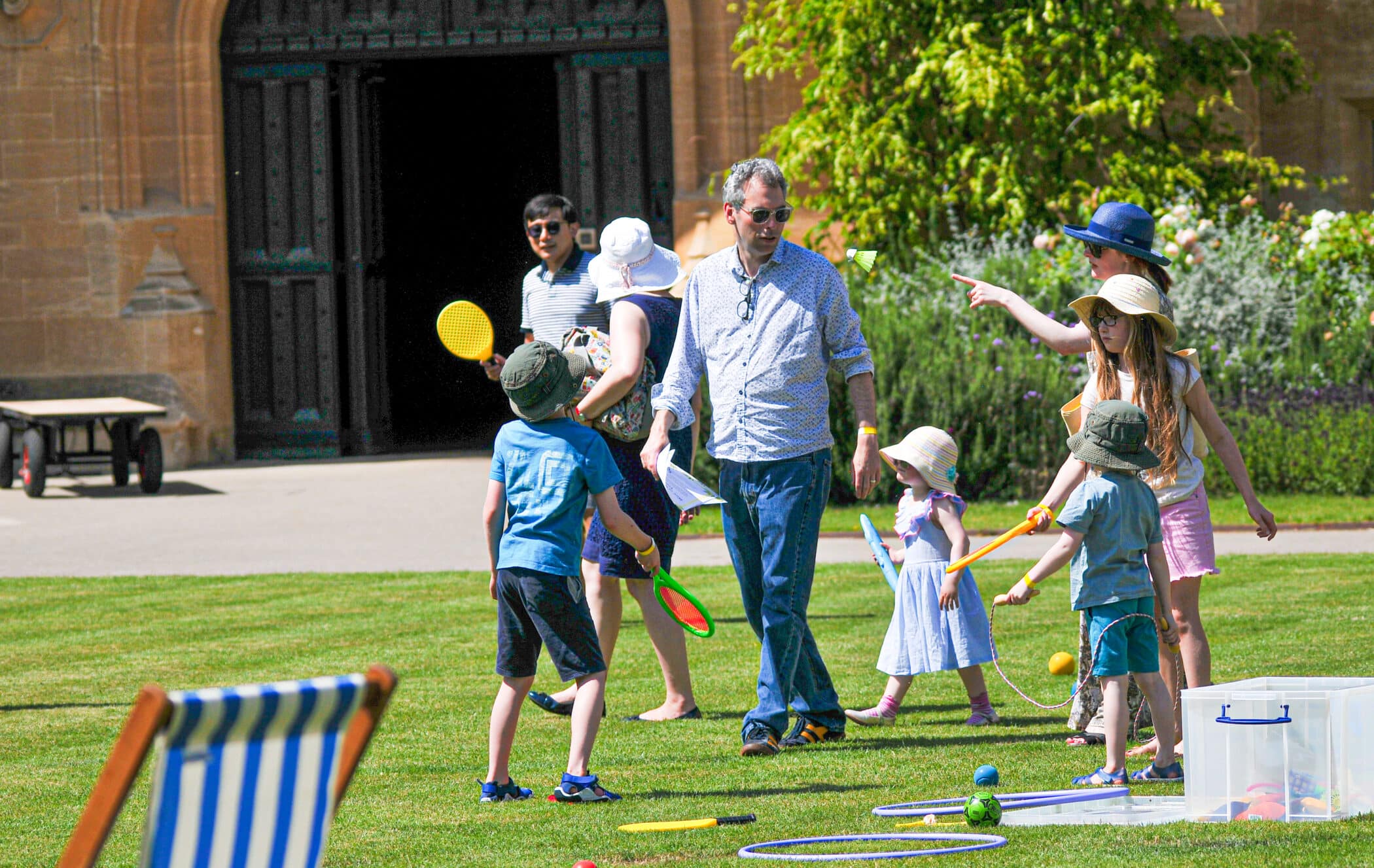 adult and children playing on the quad