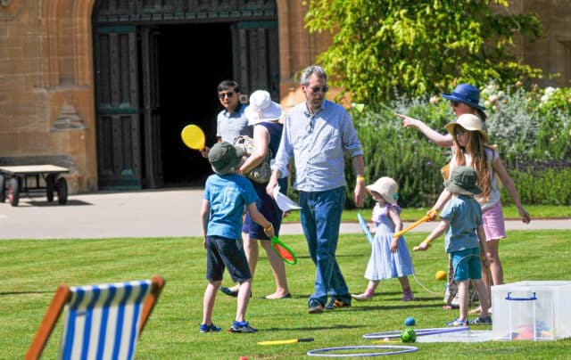 adult and children playing on the quad