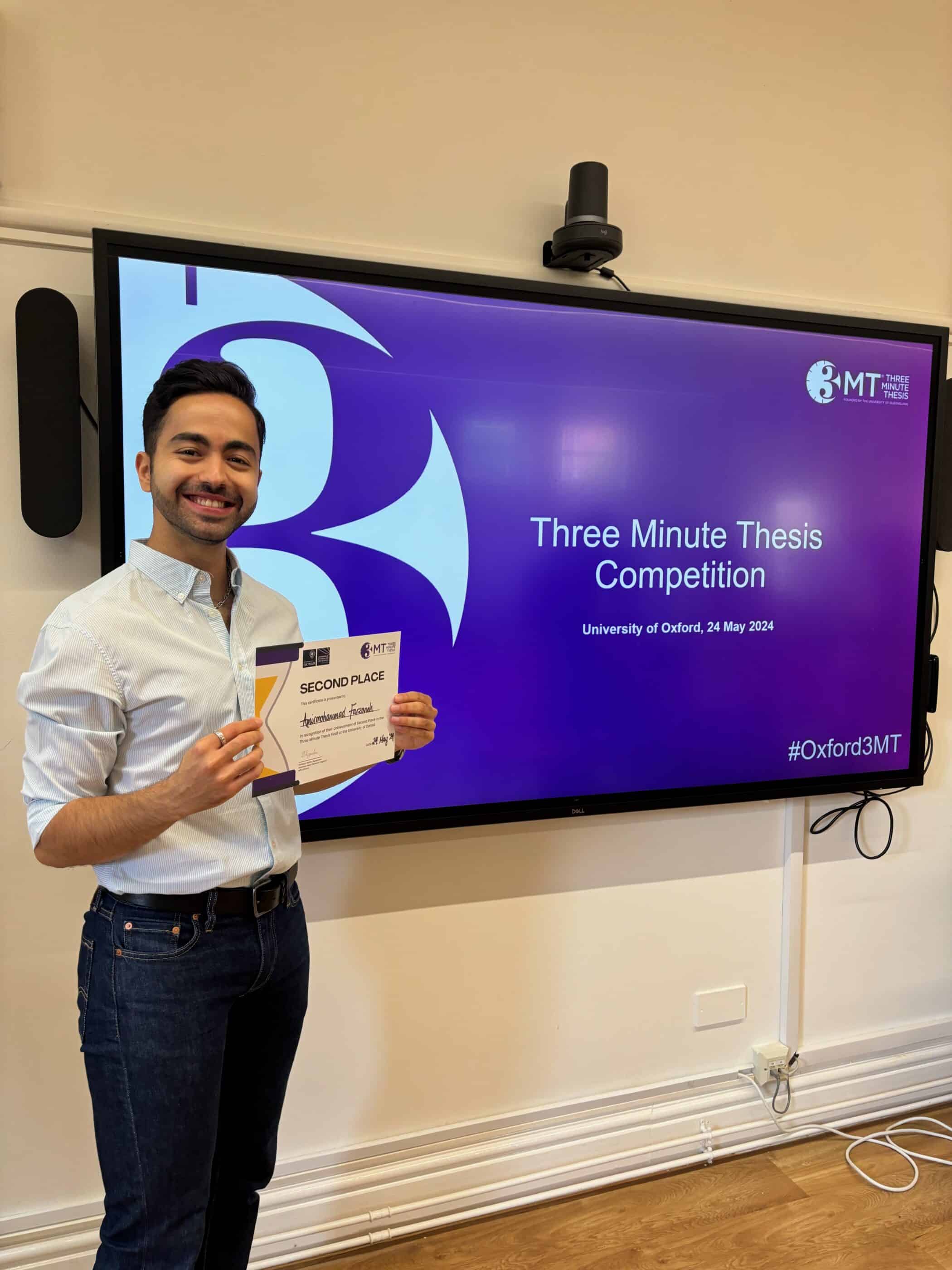 Amirmohammad Farzaneh holding his certificate for Three Minute Thesis Competition