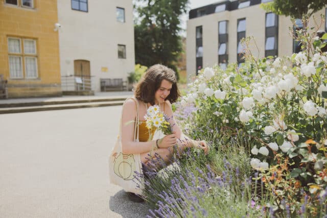 Student picking flowers.