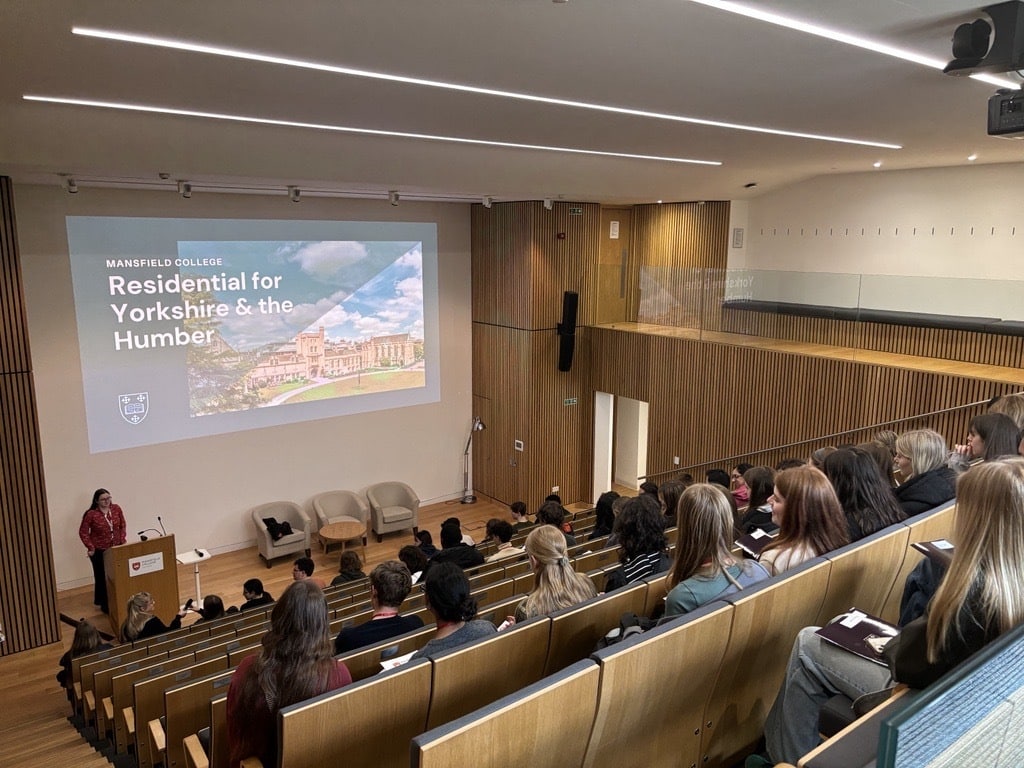 Students in the auditorium listening to a welcome talk.