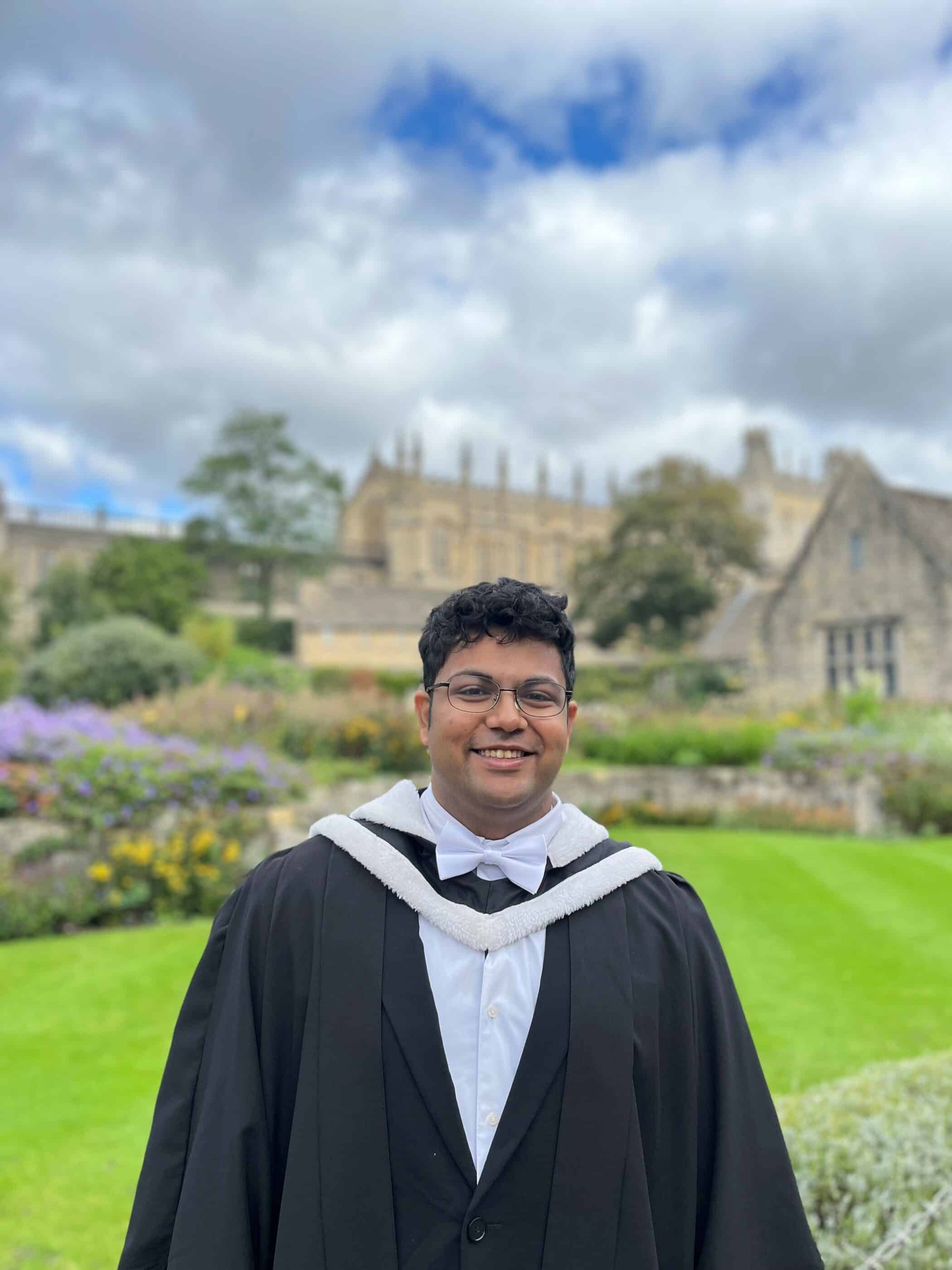 headshot of Shatikk in his graduation gown outside Christ Church College Memorial Garden