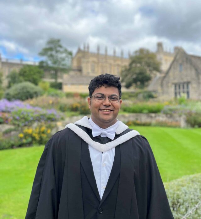 headshot of Shatikk in his graduation gown outside Christ Church College Memorial Garden