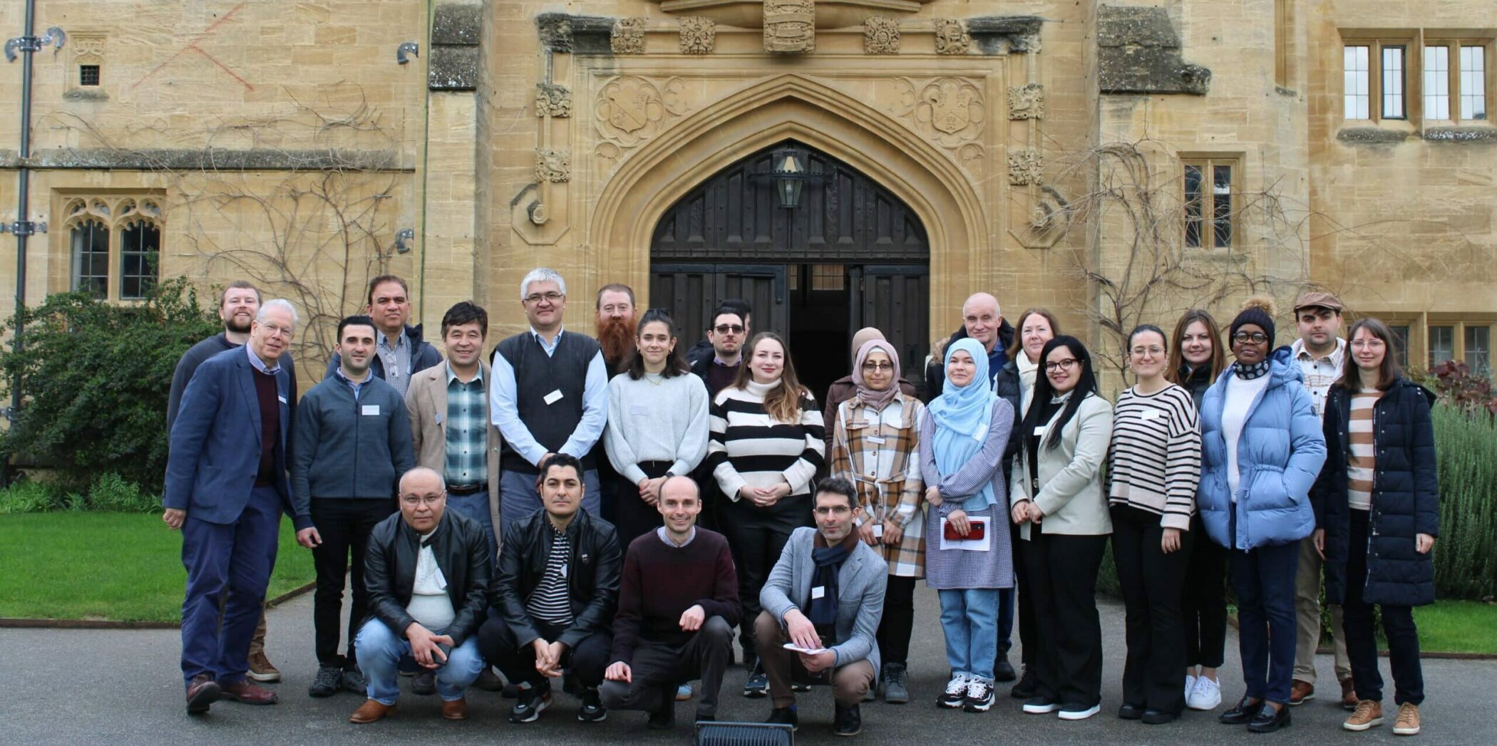 group photo of STEM Sanctuary 2024 attendees outside entrance of the Mansfield Tower building